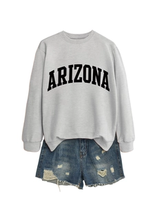 Detail of Arizona print sweatshirt and distressed denim shorts with frayed hems