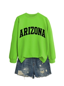 Flat lay of green Arizona sweatshirt paired with distressed denim shorts for casual style