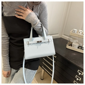 Light blue lychee pattern leather tote bag shown with silver twist lock and strap