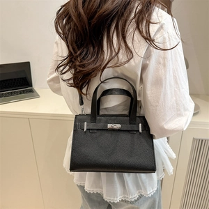 Classic black pebbled leather tote bag with silver metal turn-lock and strap details