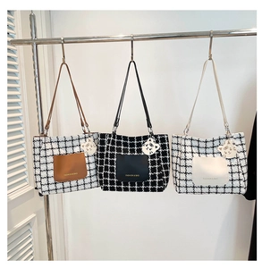 Detailed view of three checkered tweed tote bags with front leather pockets and charms