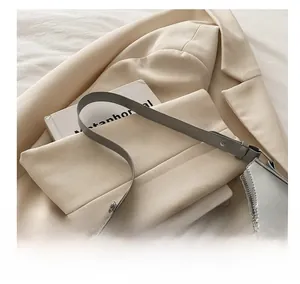 Detail view of silver crescent hobo bag with metallic finish and adjustable strap