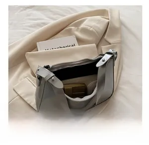 Top view of silver hobo bag interior showing storage capacity for wallet and essentials