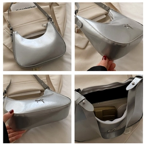 Detail view of silver baguette bag with metallic finish and bow buckle accent