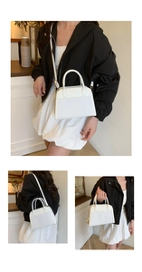 Detail showing the white woven texture and leather contrast on a stylish shell handbag