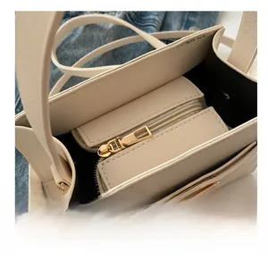 Detail of saffiano leather interior with gold zipper and compartments in beige handbag