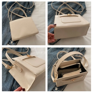 Detail view of cream structured crossbody bag showing interior pockets and bottom design