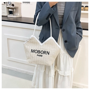 Detailed texture of straw tote bag with MOBORN PARIS logo and white leather strap
