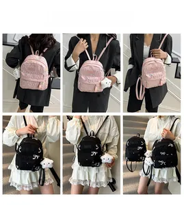Quilted mini backpacks in pink and black with bow patterns and plush star pendants