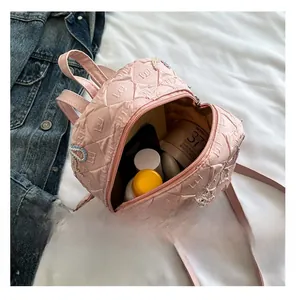 Pink quilted mini backpack interior view showing storage for cosmetics and lotions