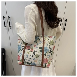 Floral print tote bag shown on shoulder for large capacity and style visualization