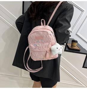 Pink quilted backpack with embroidered bow detail and cute white star plush charm