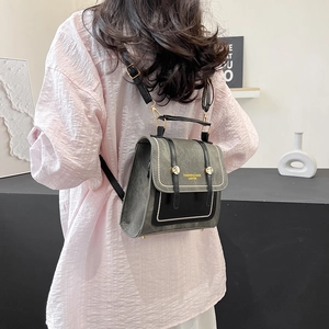 Retro grey and black mixed material backpack with metal studs and adjustable straps