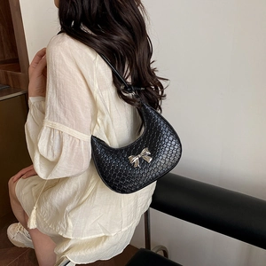 Urban chic crescent hobo bag in black woven texture with silver bow detail