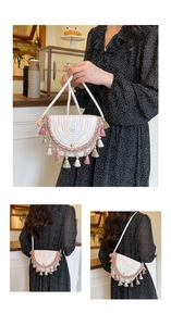 Detailed close-up of handmade woven straw crossbody bag with colorful fringe and tassels