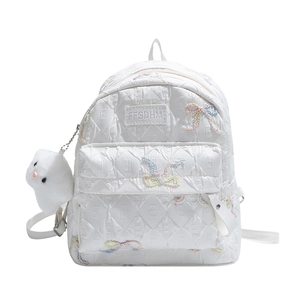 Quilted white backpack with colorful bow embroidery and a plush bunny charm decor