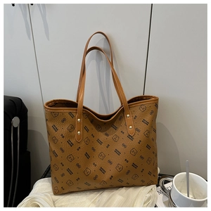 Detailed view of brown litchi pattern leather tote featuring cute cartoon bear prints