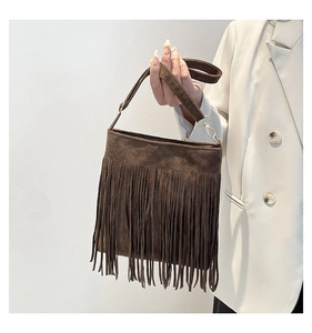 Detail of dark brown matte PU shoulder bag featuring long bohemian style fringe tassels