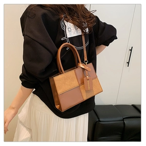 Detail of color-block patchwork textures and circular handle on vintage crossbody bag