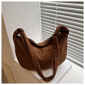 Detail of caramel corduroy tote showing thick ribbed texture and adjustable shoulder strap