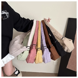 Macro detail of various corduroy crossbody bags showing rib texture and zipper