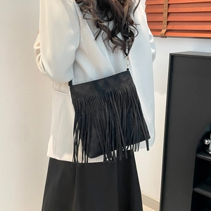 Retro black suede shoulder bag with long fringes and slim strap for casual commuting