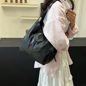 Minimalist black pebbled leather tote bag with stitch details and large capacity