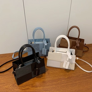 Chic patchwork crossbody tote bags in four colors on a wooden surface in 45-degree view