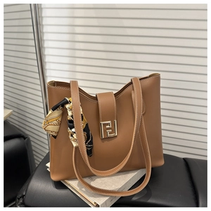 Brown leather tote bag featuring a gold geometric buckle and vintage floral silk scarf accent