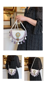 Detail of bohemian white woven bucket bag with purple tassels and beaded disk