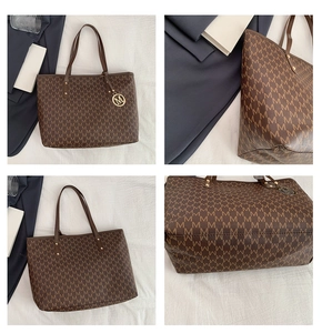 Detail view of large brown vintage tote bag with M-pattern print and gold hardware