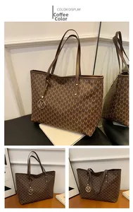 Detailed view of coffee tote bag with letter print and M-shaped metal logo pendant