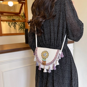 Bohemian white hand-woven crossbody bag with purple geometric patterns and fringe tassels