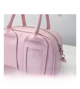 Detail view of pink shell bag with clear card slot and silver metal hardware