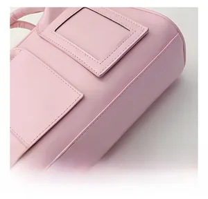 Detail of pink PU leather shell bag showing precision stitching and card slot compartment