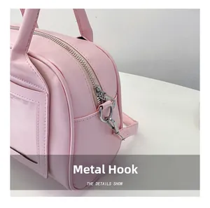 Detail of silver metal hooks and premium PU leather texture on pink shell bag