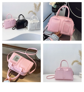 Detail of trendy shell bag featuring a transparent card slot and adjustable shoulder strap