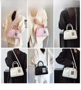 Three minimalist shell bags in pink, white, and black with transparent card slots