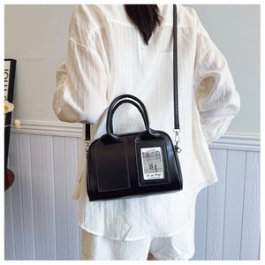 Detail of black shell bag with card slot and adjustable shoulder strap for women