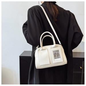 Chic cream leather shell bag with vintage photo insert shown on model in black blazer