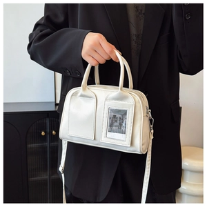 Detailed view of white PU leather shell bag with unique photo window and silver hardware