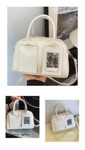 Detail view of cream leather handbag with dual front pockets and transparent photo window