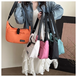 Multi-color nylon crossbody bags with adjustable straps and fashion label in detail