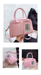 Close-up of pink shell-shaped crossbody bag with transparent card window and shoulder strap