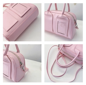 Detail view of light pink matte PU leather shell bag with clear card slot and silver zipper