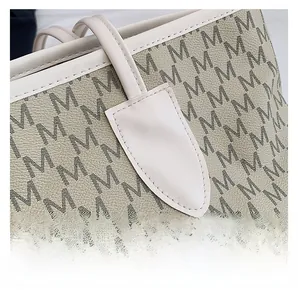Macro shot of high-quality stitching and printed leather texture on a tote bag