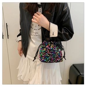 Detail of colorful sequins and black drawstring closure on the stylish bucket bag