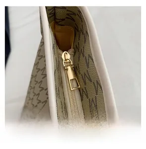 Macro detail of the high-quality gold zipper and monogram pattern on the tote bag