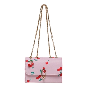 Pink shoulder bag with cherry print, gold chain strap and cherry pendant charm