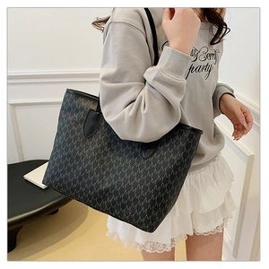 Detail of grey monogram tote bag with large capacity for commuting and fashion use
